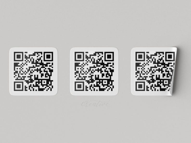 three white stickers with black QR codes on them, arranged in a row.