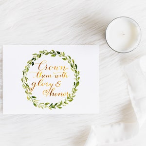 May include: A white card with a gold calligraphy quote "Crown them with glory & honour" surrounded by a green watercolour wreath.
