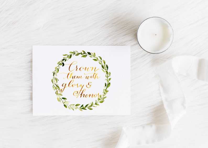 May include: A white card with a gold calligraphy quote "Crown them with glory & honour" surrounded by a green watercolour wreath.