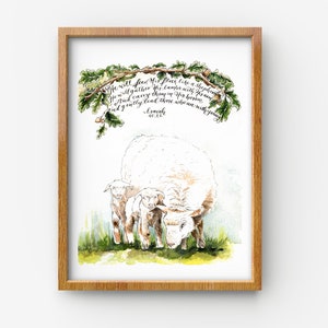 May include: Watercolor painting of a white sheep with two lambs. The painting is framed in a light wood frame. The text "He will feed his flock like a shepherd. He will gather his lambs with his arm. And carry them in his bosom, and gently lead those who are with young." is written in calligraphy above the sheep.