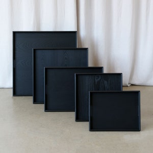 5 size options of the black trays with handles