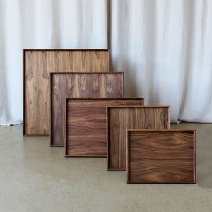 Image of 5 ottoman tray options, rectangular and square trays in walnut.