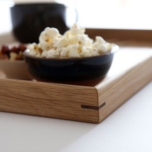 Contrasting walnut wood corner pin detail on a oak ottoman tray