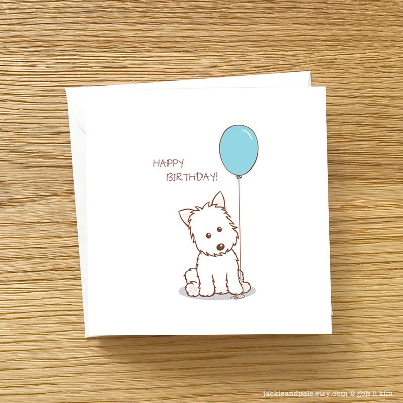 May include: A white card with a cartoon white dog holding a light blue balloon. The card says "Happy Birthday!" in brown text.