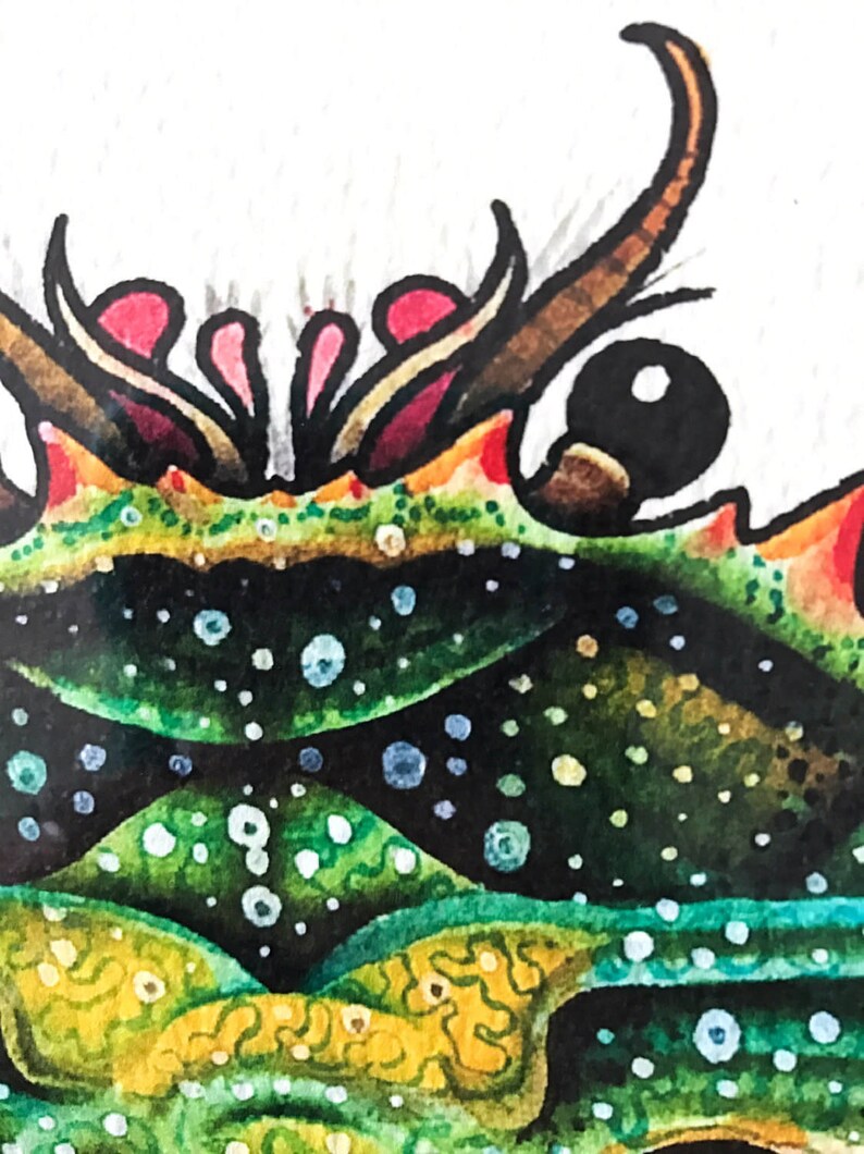 May include: Close-up of a watercolor painting of a green and yellow creature with a black eye and red and pink accents. The creature has a spiky, textured surface.