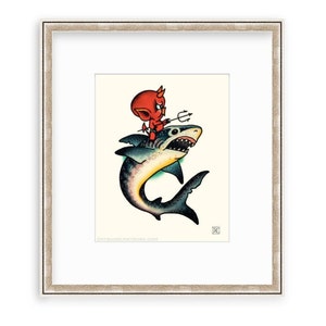 May include: A red devil with a trident sits on the back of a blue and green shark with a white belly. The shark has a large open mouth with sharp teeth. The image is in a white frame with a light brown border.