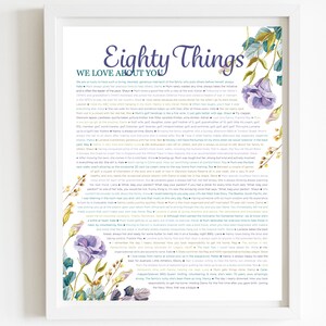 May include: A framed print with a floral design and the text "Eighty Things We Love About You". The text lists 80 reasons why someone is loved, including their personality traits, hobbies, and accomplishments.