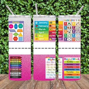 May include: Three pink glitter tumblers with different educational designs. The first tumbler features a chart with shapes and their names. The second tumbler has a chart with the months of the year. The third tumbler has a chart with numbers 1-10 and a chart with the days of the week.