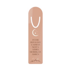 May include: A peach-colored bookmark with a white crescent moon and stars design. The bookmark features the names Feyre, Rhysand, Cassian, Nesta, Azriel, Morrigan, and Amren in white text.