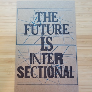May include: A brown card with blue lines and the text "The future is intersectional" in black.