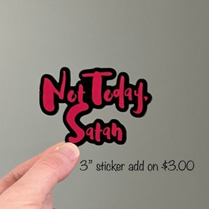 May include: A 3-inch sticker with the text "Not Today, Satan" in black lettering with a pink outline.