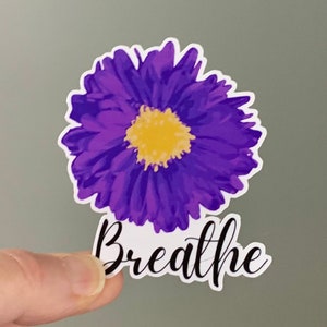 May include: Purple flower sticker with a yellow center and the word "Breathe" in black cursive lettering.