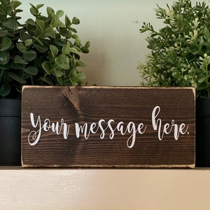 Personalized/custom small wood sign. It comes in three sizes and various fonts. Two sizes sit on a flat surface;one hangs on the wall