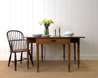 An Antique English Victorian Drop Leaf Dining Table