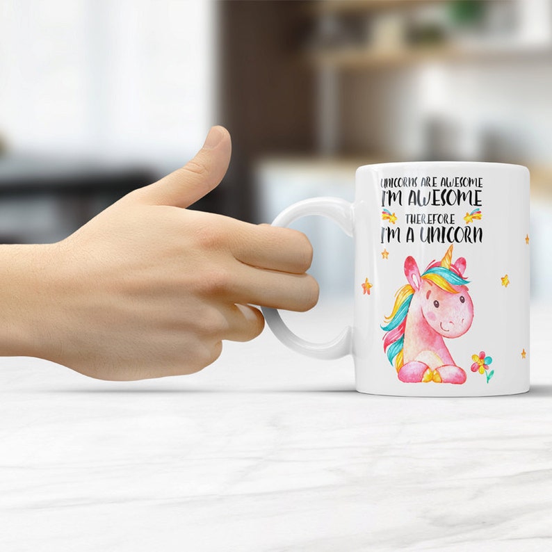 May include: White ceramic mug with a pink unicorn illustration and the text "Unicorns are awesome I'm awesome therefore I'm a unicorn".