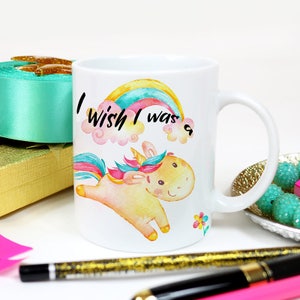 May include: White ceramic mug with a colorful rainbow and a cartoon unicorn with the text "I wish I was a..." printed on it.