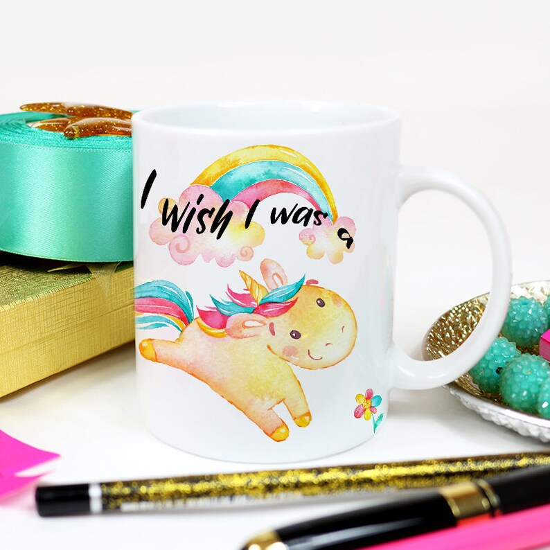 May include: White ceramic mug with a colorful rainbow and a cartoon unicorn with the text "I wish I was a..." printed on it.