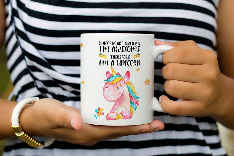 May include: White ceramic mug with a pink unicorn illustration and the text "Unicorns are awesome I'm awesome therefore I'm a unicorn".
