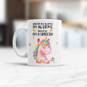 May include: White ceramic mug with a pink unicorn illustration and the text "Unicorns are awesome I'm awesome therefore I'm a unicorn".