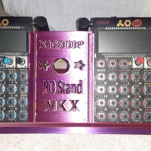 May include: A purple 3D printed stand for a Teenage Engineering PO-128 Pocket Operator synthesizer. The stand is labeled "M3IDIP PO Stand MKX".