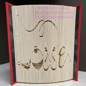 May include: A book with the word "Love" cut out of the pages. The book is bound in red and black fabric. The text on the spine reads "@CREATED_4U2 FB.COM/CREATED4U ETSY/CREATED4U2".