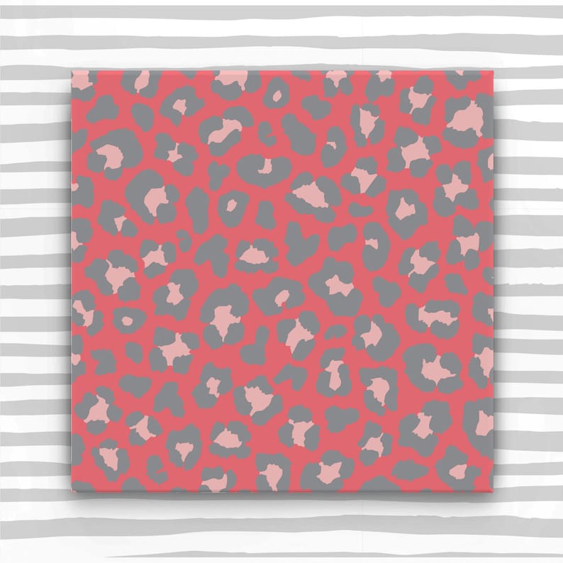 May include: A seamless pattern featuring a pink and gray leopard print. The background is a solid pink color, and the leopard spots are a light gray color.