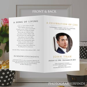 May include: A black and white funeral program with a gold border. The front features a poem titled "A Song of Living" by Dorothy Parker. The back features a photo of a man in a suit and the text "A Celebration of Life" with the name John Tran and dates August 13, 1990 - December 29, 2015. The program also includes the name of the church, the date of the service, and the name of the officiant.