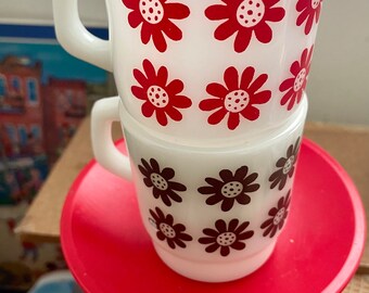Four Fire King Anchor Hocking stacking mugs daisy and atomic patterns, all very good condition.