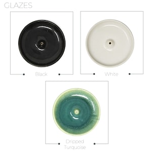 May include: Three ceramic incense holders in different glazes: black, white, and a green and blue turquoise glaze. The holders are round and have a small hole in the center.