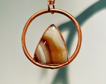 Banded agate cabochon with circle copper necklace