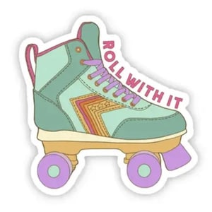 May include: A green and purple roller skate with a pink "ROLL WITH IT" text on the side. The skate has a rainbow stripe design on the side.
