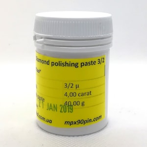 May include: A white plastic jar with a yellow label that reads "Diamond polishing paste 3/2" and includes details like "3/2 μ", "4,00 carat", "40,00 g", and "T JAN 2019". The label also includes the website "mpx90pin.com".