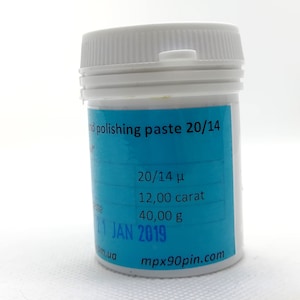 May include: A white plastic jar with a blue label that reads "nd polishing paste 20/14", "20/14 μ", "12,00 carat", "40,00 g", "21 JAN 2019", "mpx90pin.com", and "om.ua".