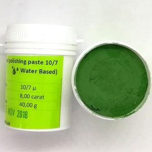 May include: A green polishing paste in a white jar with a green lid. The jar is labelled "polishing paste 10/7 Water Based)" and has the following information: 10/7 µ, 8.00 carat, 40.00 g, 5 NOV 2018.