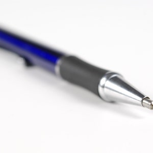 May include: A blue and silver mechanical pencil with a sharp point.