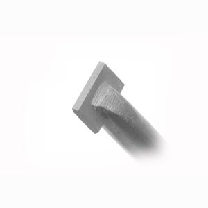May include: A close-up of a metal object with a square head and a cylindrical body. The object is silver and appears to be made of steel. The background is plain white.