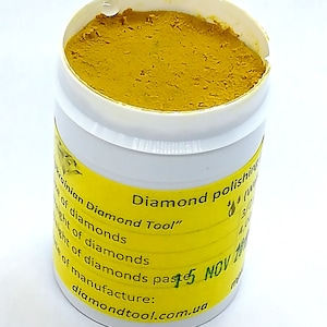 May include: A yellow container of diamond polishing paste labelled "Ukrainian Diamond Tool" with the date "15 NOV 2014" and the website "diamondtool.com.ua".
