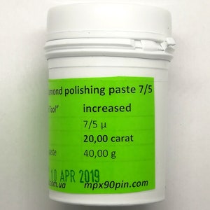 May include: A white plastic jar with a green label that reads "Diamond polishing paste 7/5 increased 7/5 μ 20,00 carat 40,00 g 10 APR 2019 mpx90pin.com".