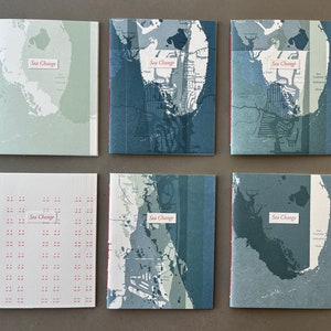 May include: Six small, bound books with a map design on the cover. Each book has the title "Sea Change" printed in red on the front cover.