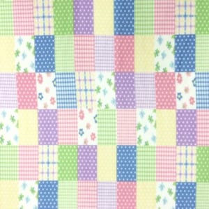 May include: A patchwork fabric with a variety of patterns in pink, blue, green, and yellow. The patterns include polka dots, gingham, and floral designs.
