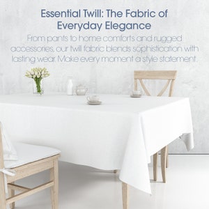 May include: A white tablecloth with a white vase of white flowers, a white pitcher, a white teapot, and two white teacups on a wooden table with two wooden chairs. The text "Essential Twill: The Fabric of Everyday Elegance" is at the top of the image.