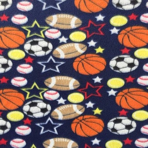 May include: Navy blue fabric with a repeating pattern of various sports balls, including basketballs, footballs, baseballs, and soccer balls. The pattern also includes red and yellow stars.