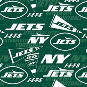 May include: Green and white fabric with a repeating pattern of the New York Jets logo. The logo features the words "Jets" and "New York" in white text on a green background. The fabric also includes the words "J-E-T-S" and "Gotham City Football" in white text.