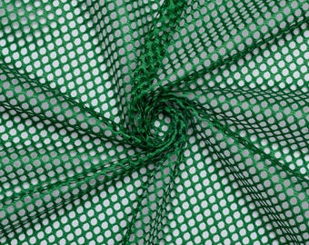 May include: Green mesh fabric with a diamond pattern. The fabric is folded and twisted, creating a swirling effect.