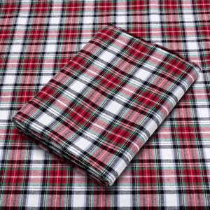 May include: Red, white, and green plaid fabric with a folded piece of the same fabric on top.