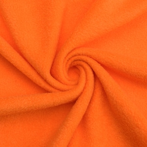 May include: Close-up of a vibrant orange fleece fabric. The material is soft and plush, with a slightly textured surface. The fabric is arranged in a swirling pattern, showcasing its flexibility and drape. Ideal for apparel, blankets, or craft projects.