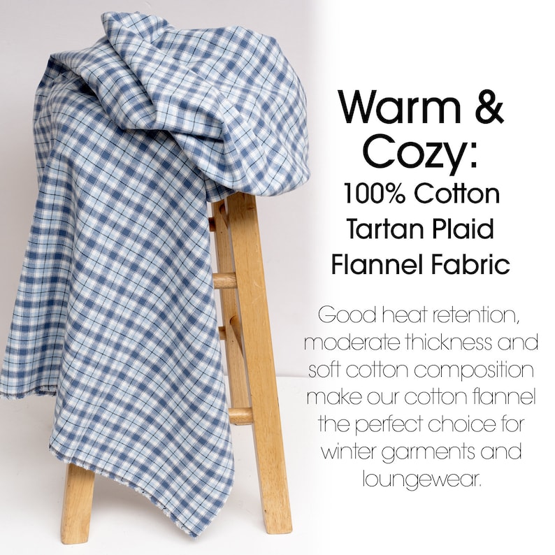 May include: A blue and white tartan plaid flannel fabric draped over a wooden stool. The fabric is 100% cotton and has a classic check pattern. Text on the right reads "Warm & Cozy: 100% Cotton Tartan Plaid Flannel Fabric."