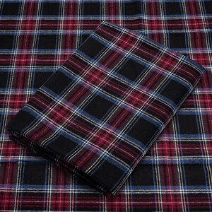 May include: Black and red plaid fabric with a white and blue plaid fabric folded on top. The fabric has a soft, textured feel.