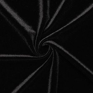 May include: Black velvet fabric with a soft, smooth texture. The fabric is folded and twisted, creating a swirling pattern.