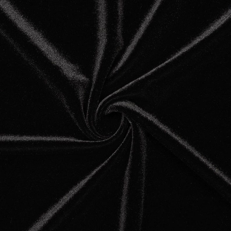 May include: Black velvet fabric with a soft, smooth texture. The fabric is folded and twisted, creating a swirling pattern.